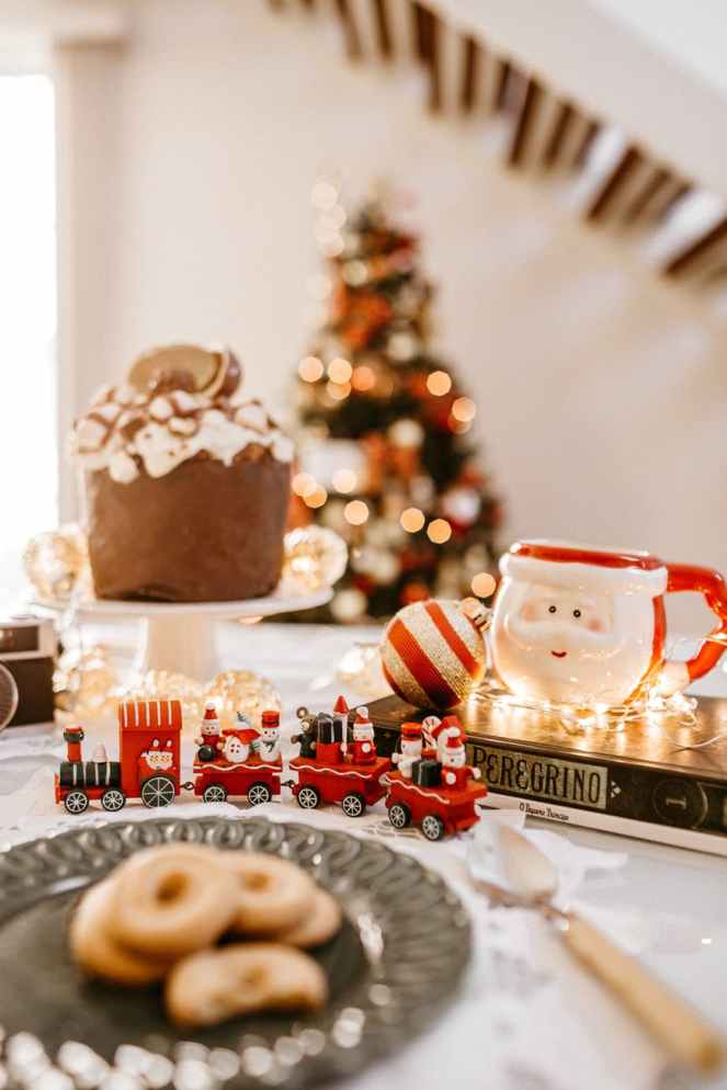 selective focus photography of christmas train and santa claus mug on table